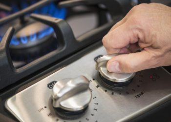 USA, New Jersey, Jersey City, Close-up of hand adjusting stove burner